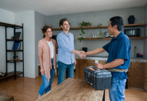 A team member from Everything Water Plumbing, Plumbers in Bloomington IL, greets homeowner